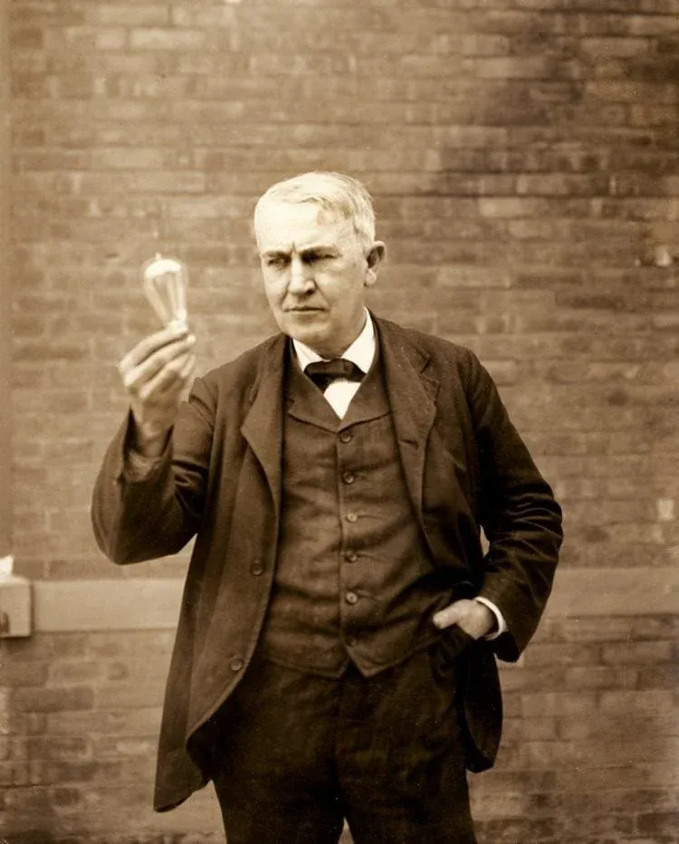 Thomas Edison Holding a Lightbulb